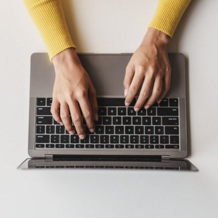 A decorative element: someone working on a laptop