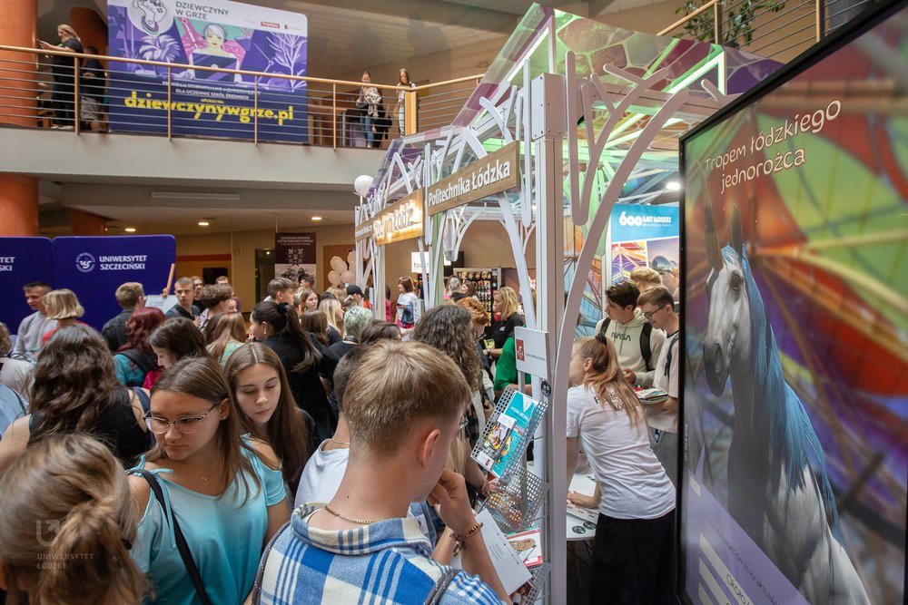crowds of young, interested people around the joint stand 