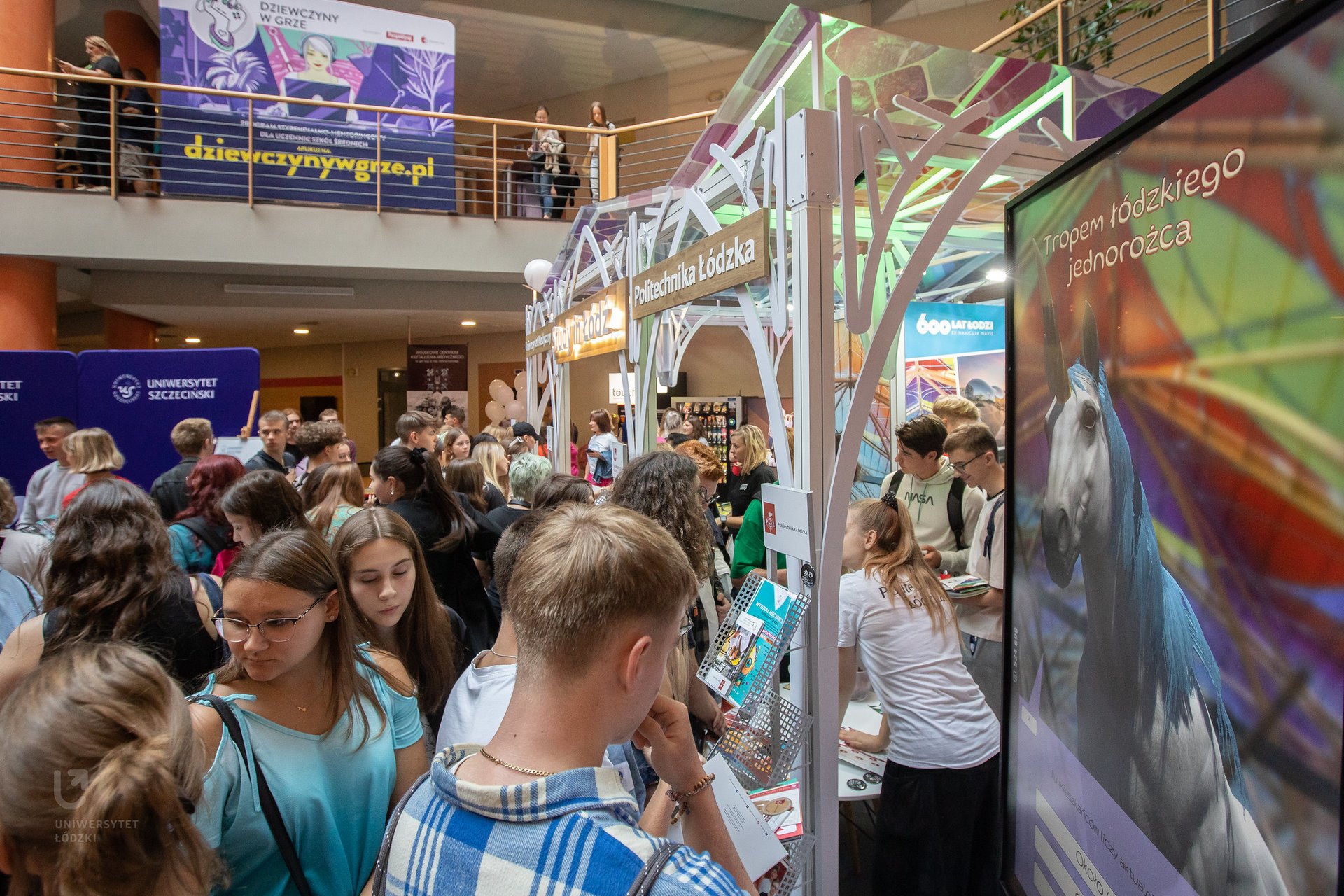 crowds of young, interested people around the joint stand 