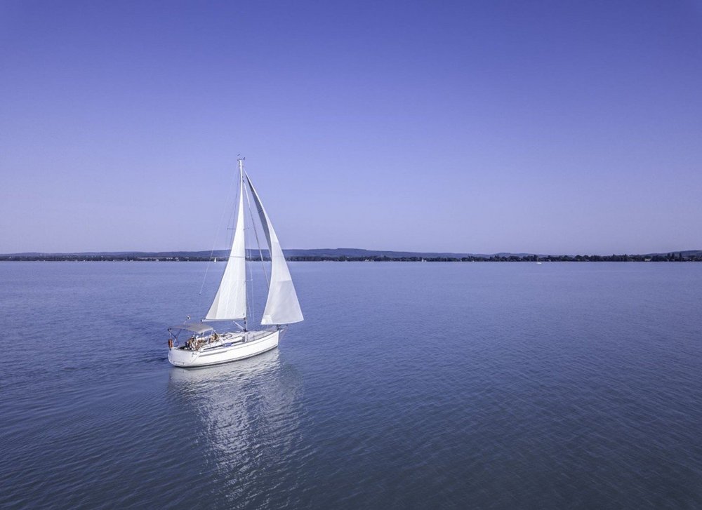 a decorative element: a photo of a sailboat on a lake