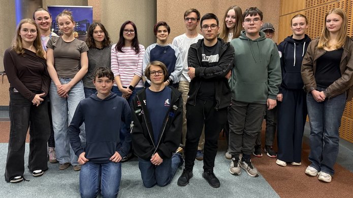 a group of young people posing for a photo in the workshop room
