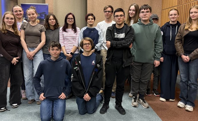 a group of young people posing for a photo in the workshop room