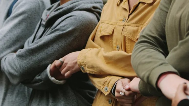 Silhouettes of people holding hands