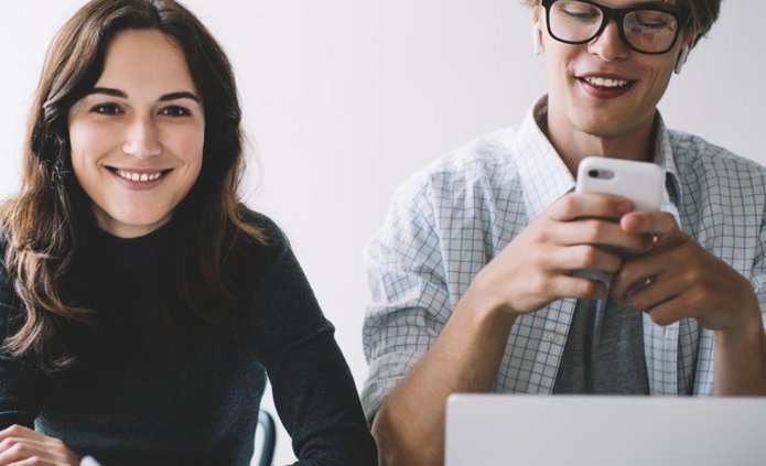 a decorative element: a smiling young woman and a man sitting at a desk